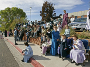 ST. GEORGE, UT - NOVEMBER 14:  Several thousand polygamy supporters from Colorado City, Arizona sit across the street from the Fourth District Courthouse, November 14, 2008 in St. George, Utah. Members of the polygamist sect in Colorado City gathered to protest the sale of anymore land from the FLDS Trust by the state of Utah. The hearing was postponed when representatives from the State of Utah and leaders from the polygamist sect agreed for the first time to negotiate the running of the trust and the sale of land. (Photo by George Frey/Getty Images)