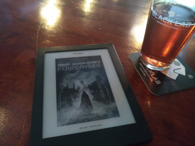 Ebook reader with said novel enjoying the Pub