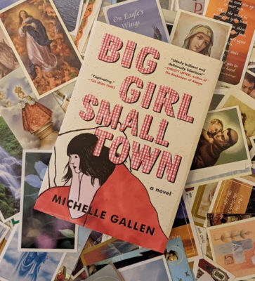 book cover with girl under red duvet, lying on a pile of catholic funeral prayer cards