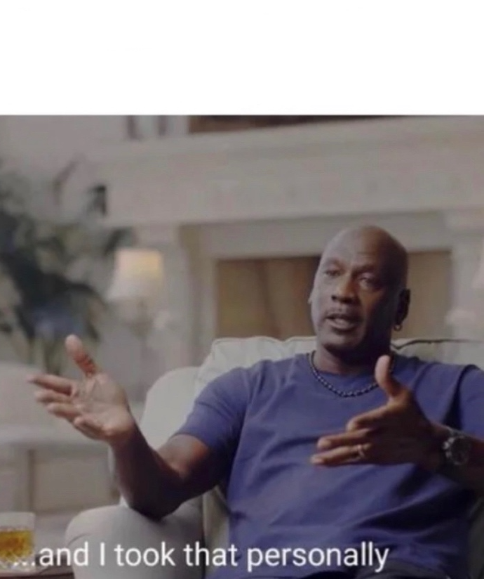 Michael Jordan, sitting in a chair, wearing a blue shirt, saying I took that personally