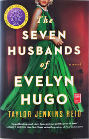 Book cover: The Seven Husbands of Evelyn Hugo. A woman stands in a glamorous green dress. We cannot see her face.