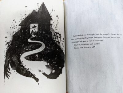 A book open with on one page an ink drawing of a house with a broken window and below are figures suggesting a face and a hand. On the next page the quote, "I dreamed of you last night. Isn't that strange? I dreamed that you were standing in the garden, looking up, I dreamed that you were waiting for the sun to rise. It never came. What do you dream of, I wonder? Do you even dream at all?"