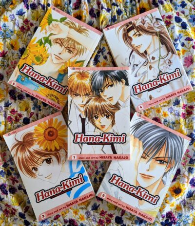 An arrangement of volumes one through five of the Japanese manga "Hana Kimi" by Hisaya Nakajo.