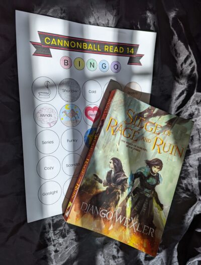 The book, "Siege of Rage and Ruin" by Django Wexler lying on top of a book bingo card. Shadows stripe across the image.