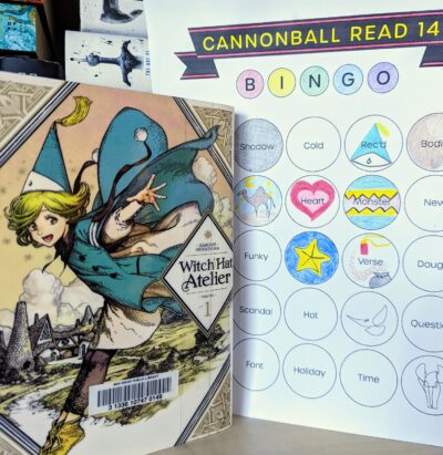 The Japanese manga, "Witch Hat Atelier" volume one next to a book bingo card.