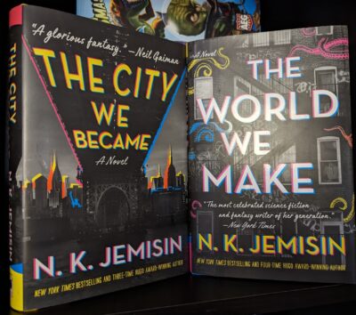 The books, "The City We Became" and "The World We Make" by N.K. Jemisin standing next to each other.