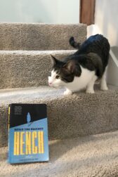 adorable cat on stairs next to book