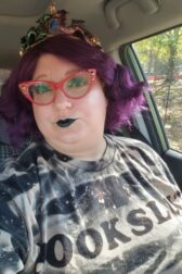 fabulous reader with purple hair and red glasses