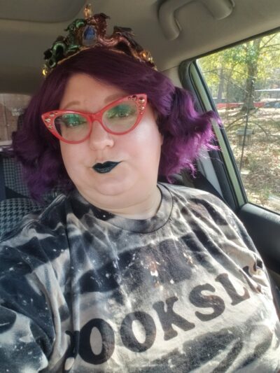 fabulous reader with purple hair and red glasses