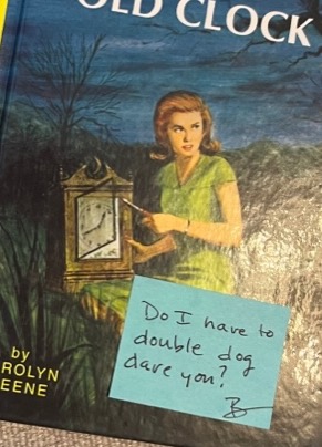 Nancy Drew novel with post-it note that says, "Do I have to double dog dare you? - B"