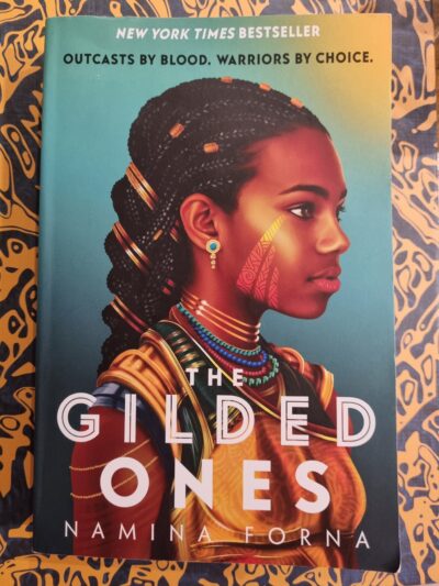 Cover of The Gilded Ones on a patterned background