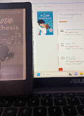 I forgot to take a picture of me reading so here is my ebook and the library hold page showing the audiobook.