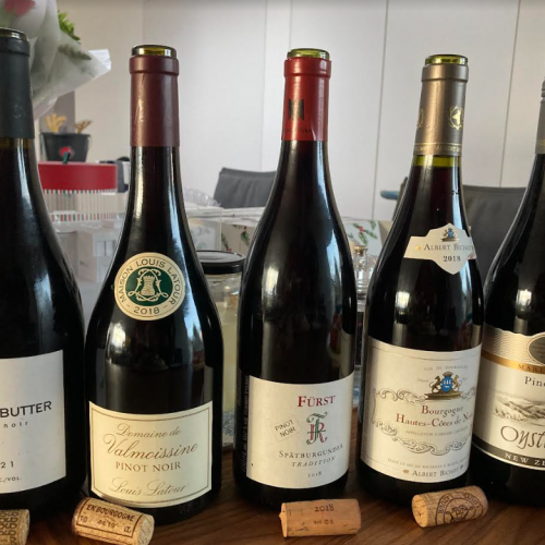 a group of pinot noir wines on a table for tasting