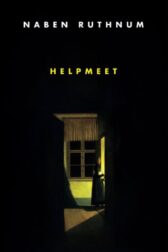 a woman stands in a darkened room illuminated by a light coming in through a doorway. she is wearing a head scarf and dress. there is a window behind her.