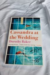 Cover of Cassandra at the Wedding. Stylised water colour pool with two redhaired girls swimming in opposite directions.