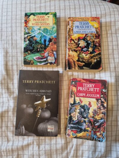 Covers of Wyrd Sisters, Witches Abroad, Lords and Ladies, and Carpe Jugulum