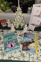 Ceramic Christmas tree with two books beneath it.