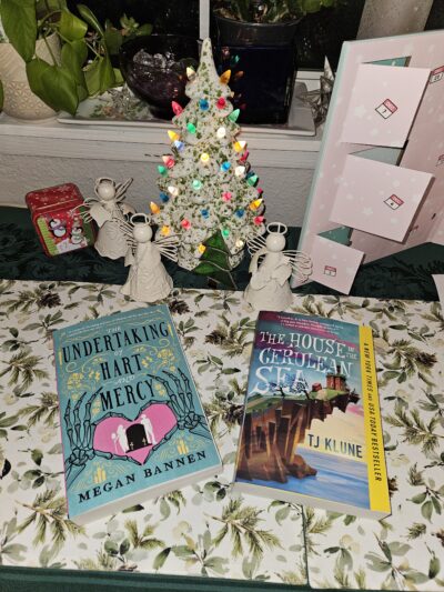 Ceramic Christmas tree with two books beneath it.