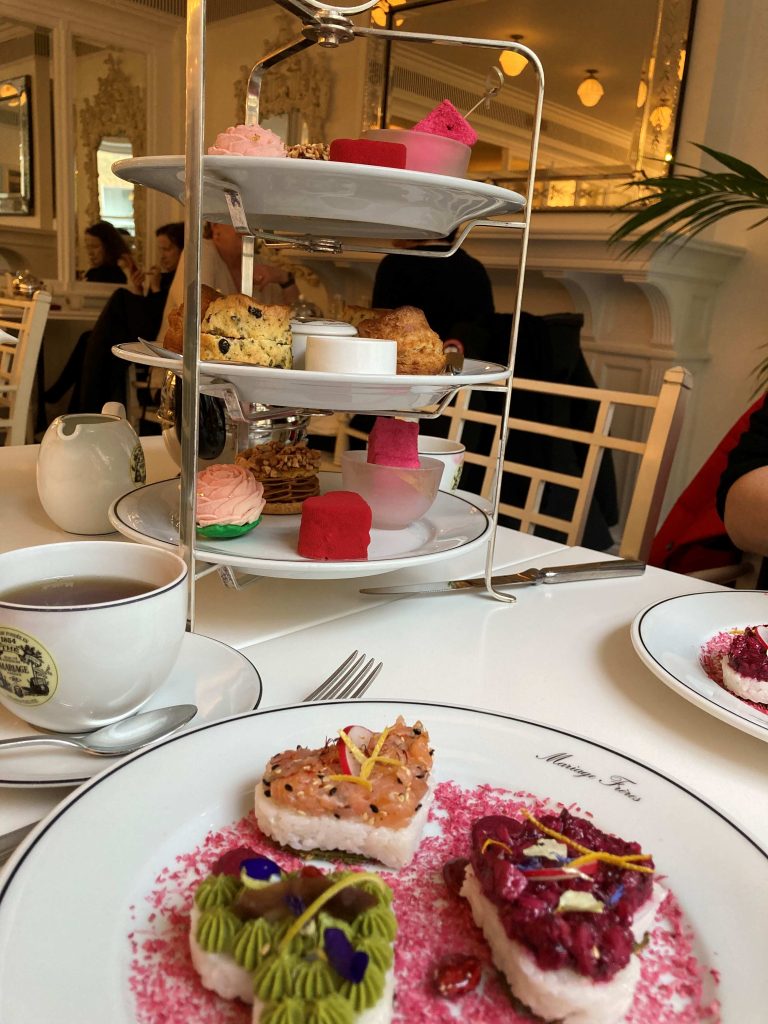 Afternoon Tea at Mariage Freres in Covent Garden London with 3 tiers of scones and cakes and a separate plate of sandwiches