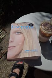 hardback copy of Gwyneth on a table with an iced latte